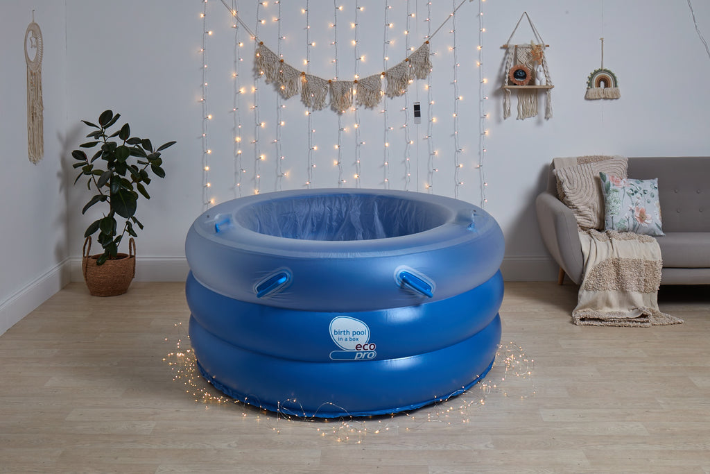Blue inflatable birthing pool in cozy home setting